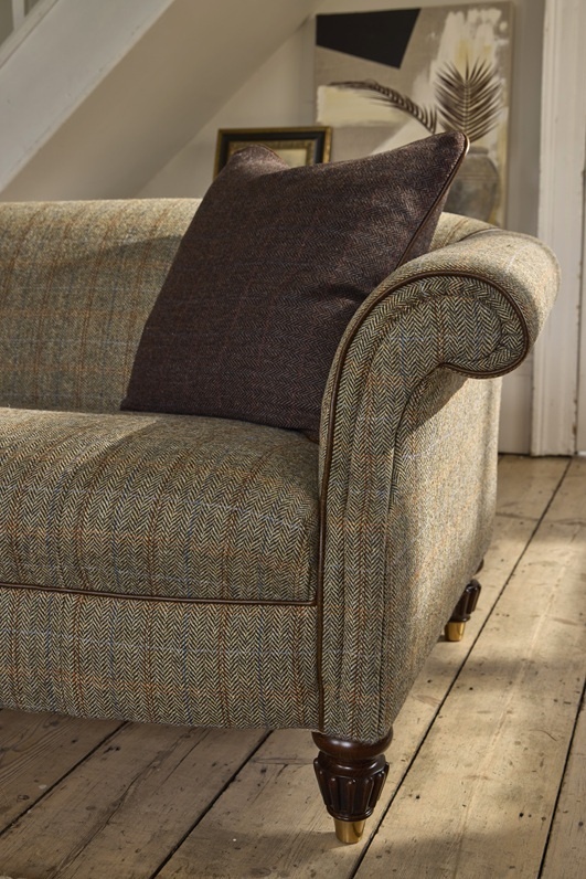 Classic fabric sofa arm detail with cushion and wooden feet